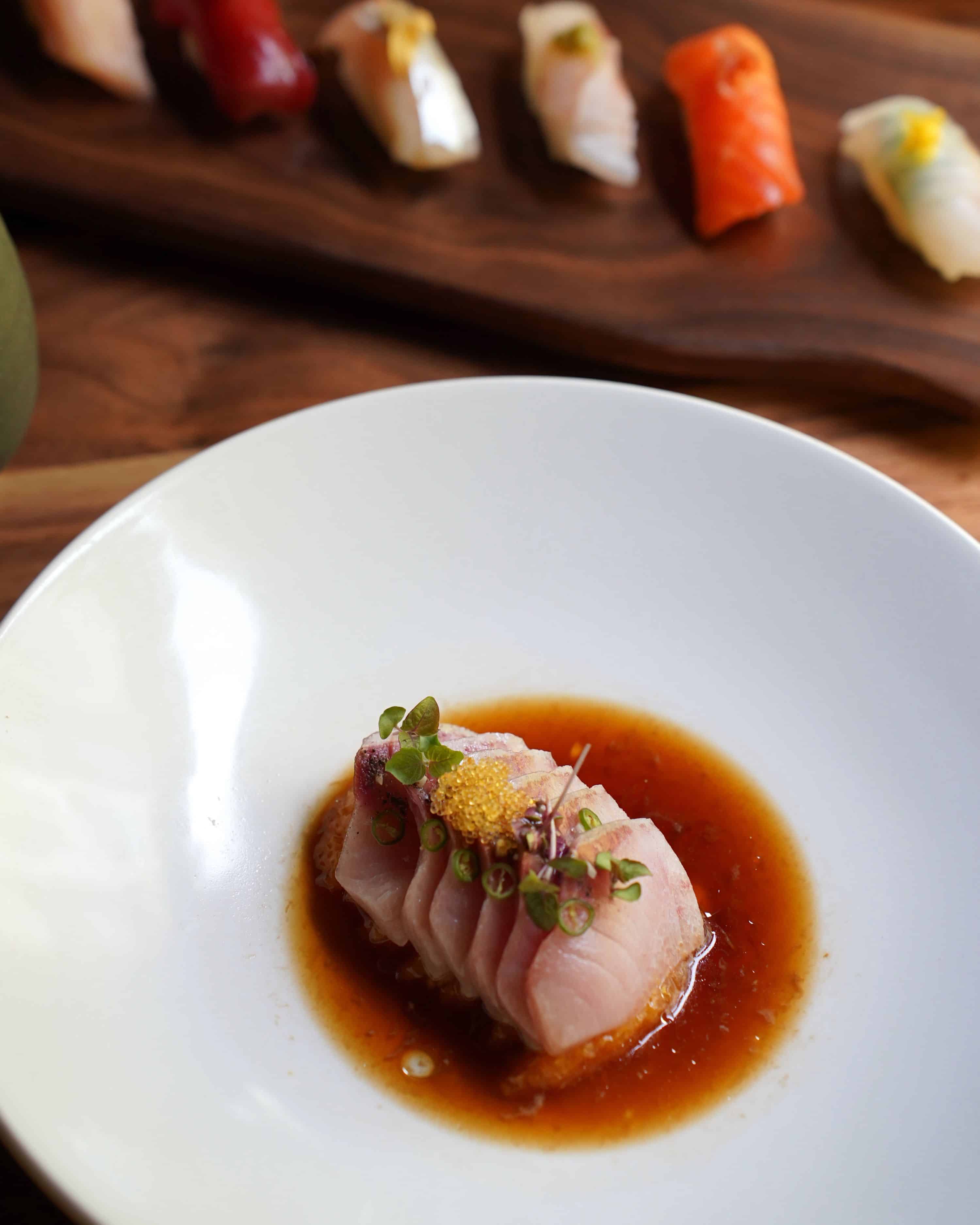 hama chili in a white bowl with nigiri on the side
