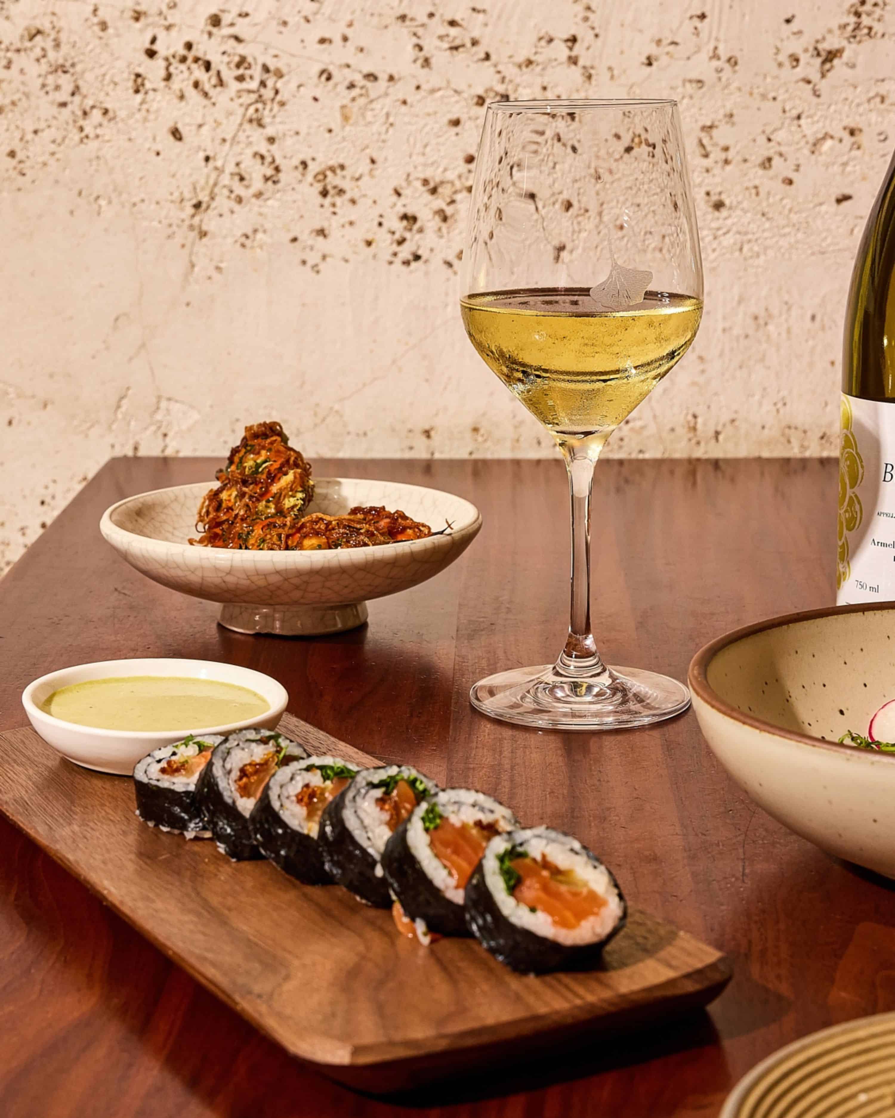 maki roll, brussels sprouts, and white wine at uchi