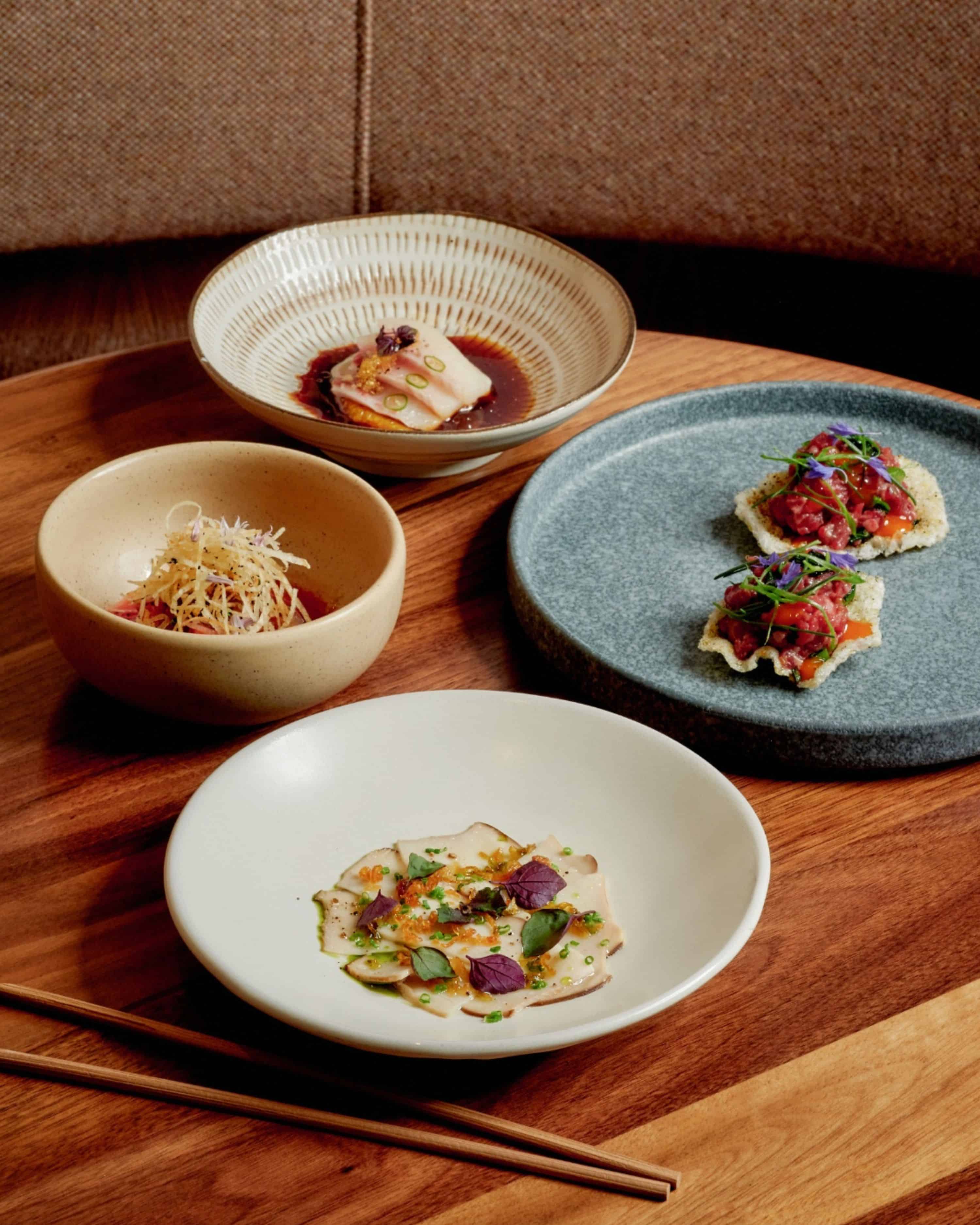 assorted small plates with sashimi tartare and crudo for dine LA menu at uchi west hollywood sushi restaurant