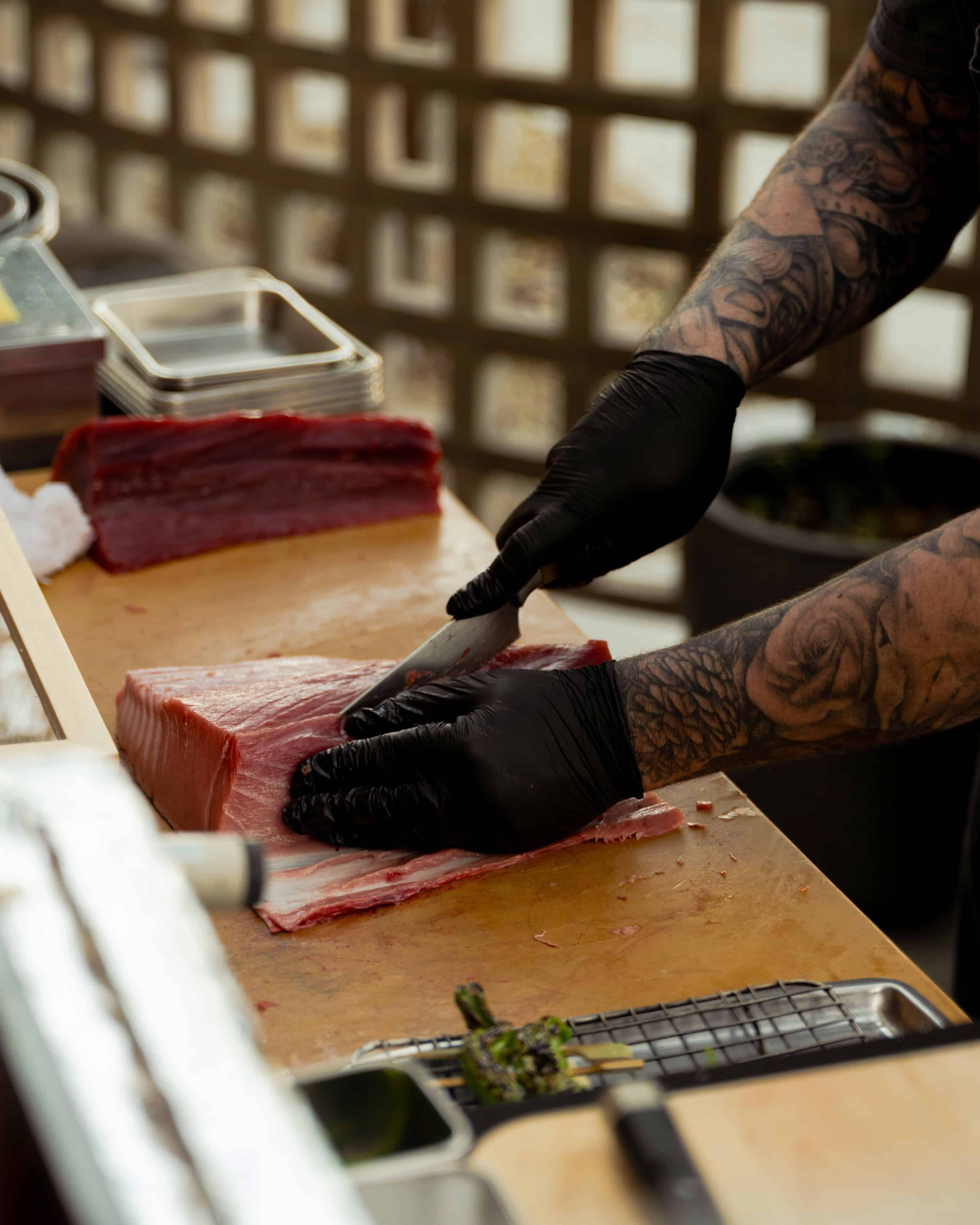 sushi chef breaking down a bluefin tune on the west hollywood patio