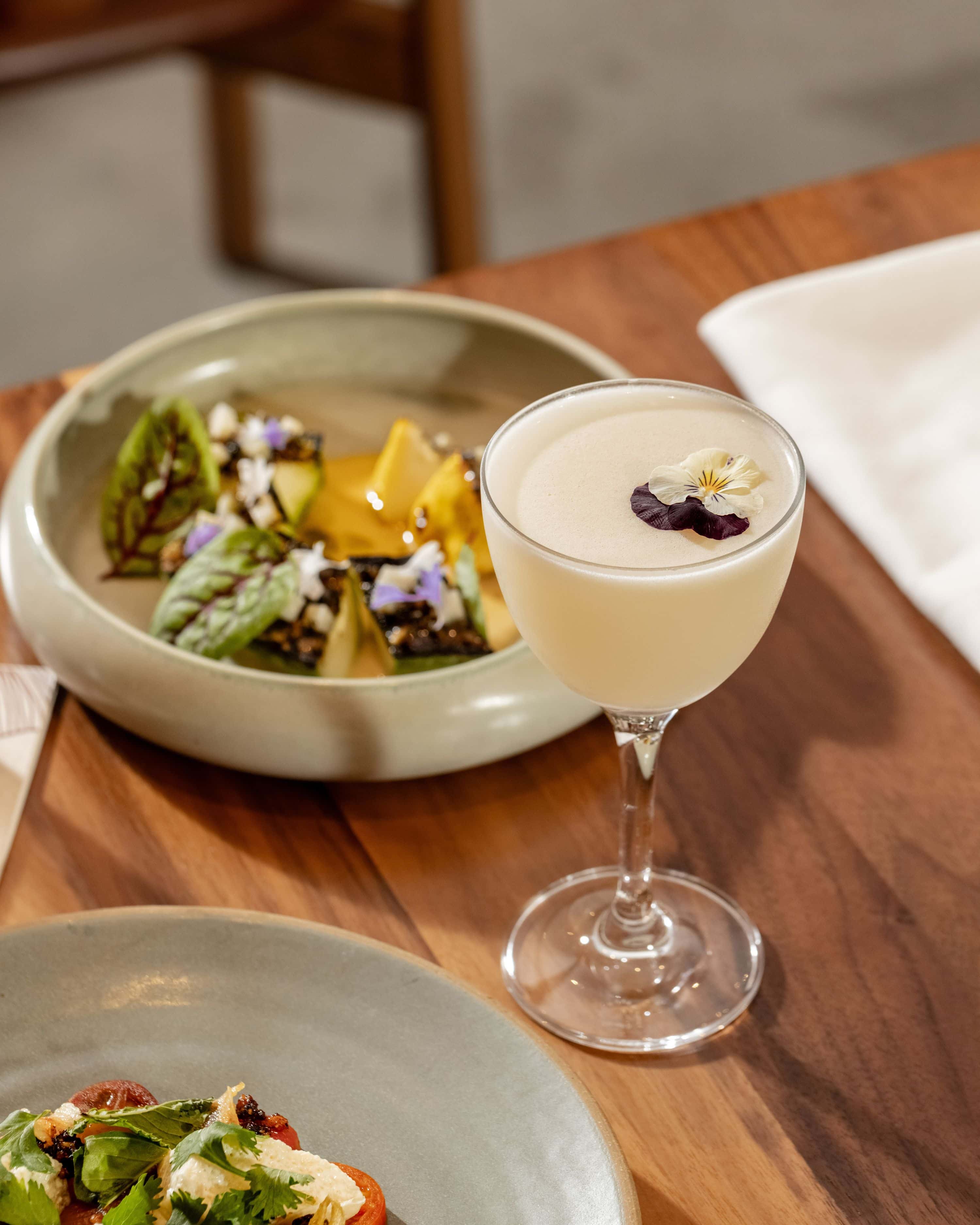 happy hour cocktail and food on the patio at uchi in west hollywood